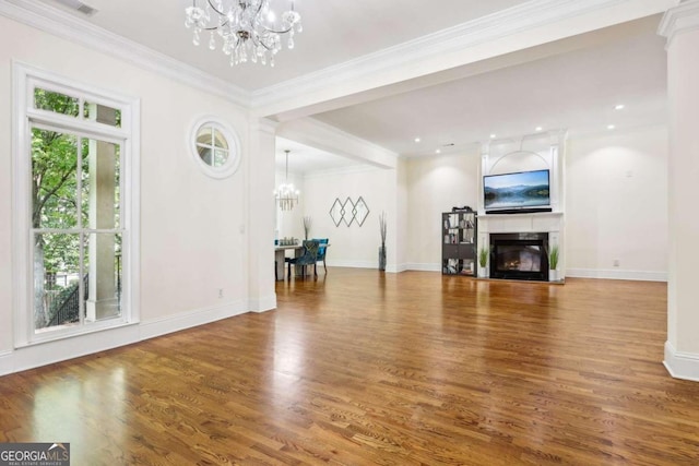 living room featuring ornamental molding, a chandelier, and wood-type flooring