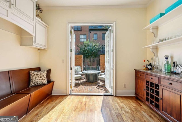 interior space with ornamental molding and light hardwood / wood-style floors