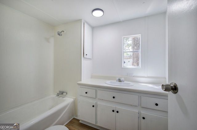 full bathroom with wood-type flooring, shower / bath combination, vanity, and toilet