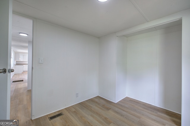 unfurnished room with light wood-type flooring