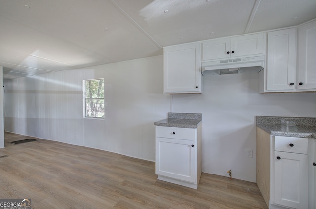 kitchen featuring light wood-type flooring and white cabinets