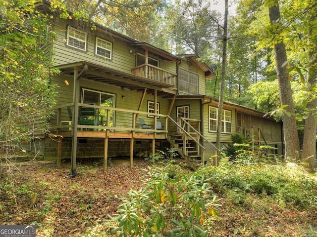 rear view of property featuring a balcony