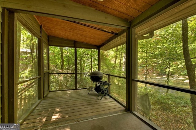 unfurnished sunroom with wood ceiling and vaulted ceiling