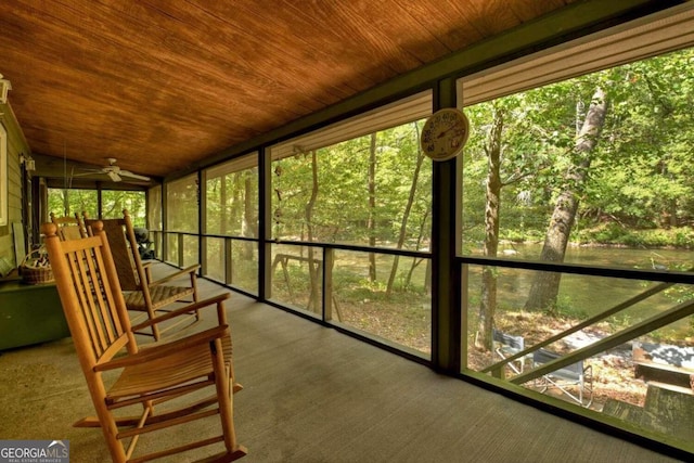 unfurnished sunroom with wood ceiling and ceiling fan