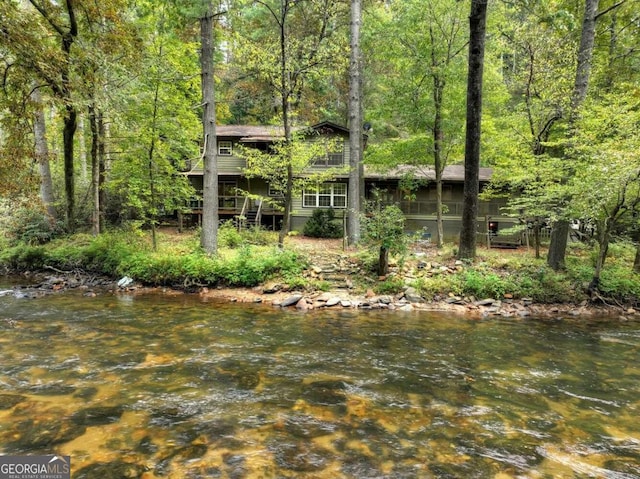 view of yard featuring a water view and a sunroom