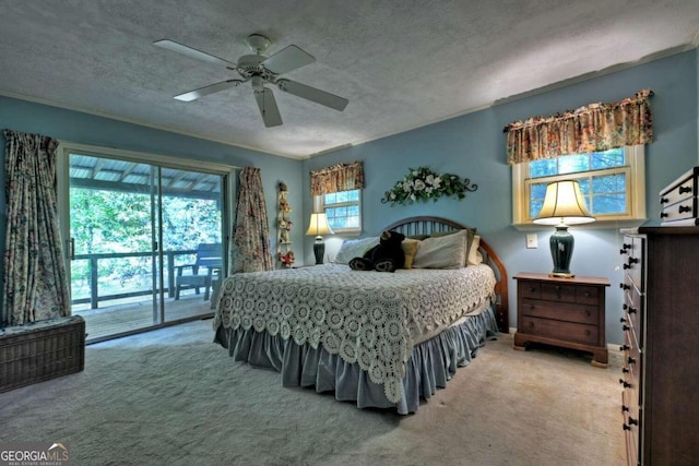 carpeted bedroom featuring ceiling fan, access to outside, and a textured ceiling