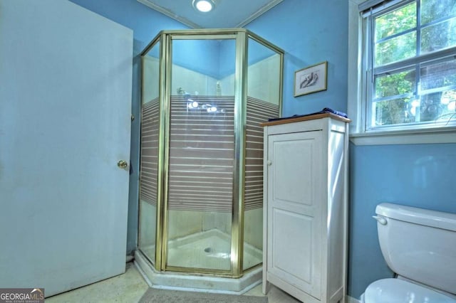 bathroom with a shower with shower door and toilet