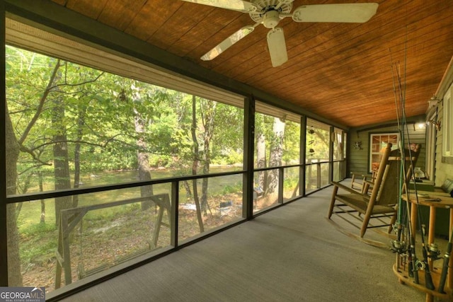 sunroom with ceiling fan, a skylight, and wooden ceiling