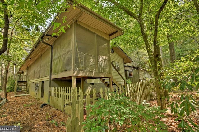 view of side of home with a sunroom