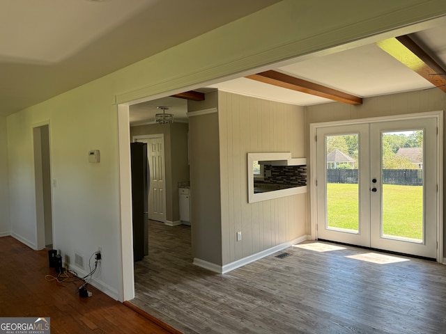 interior space featuring wood walls, beamed ceiling, hardwood / wood-style flooring, and french doors