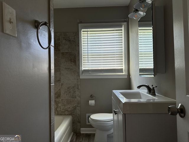 bathroom with hardwood / wood-style floors, vanity, and toilet