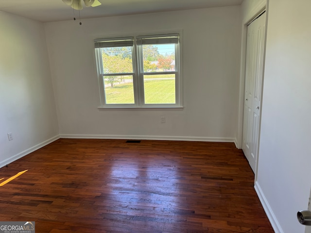 unfurnished room featuring ceiling fan and dark hardwood / wood-style flooring