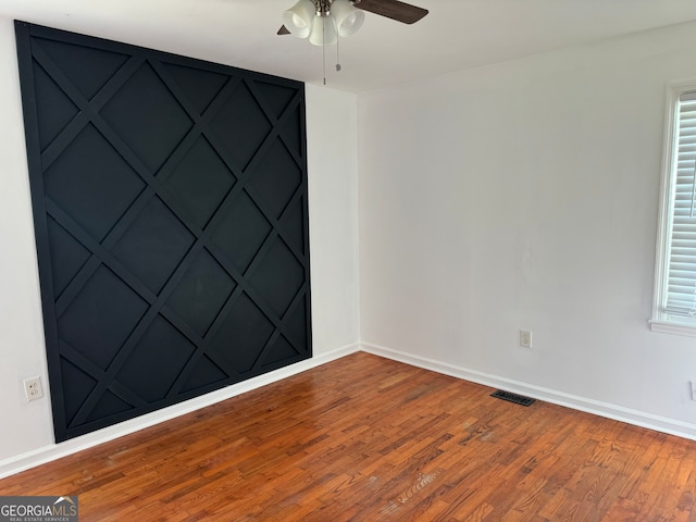 unfurnished room with ceiling fan and hardwood / wood-style floors