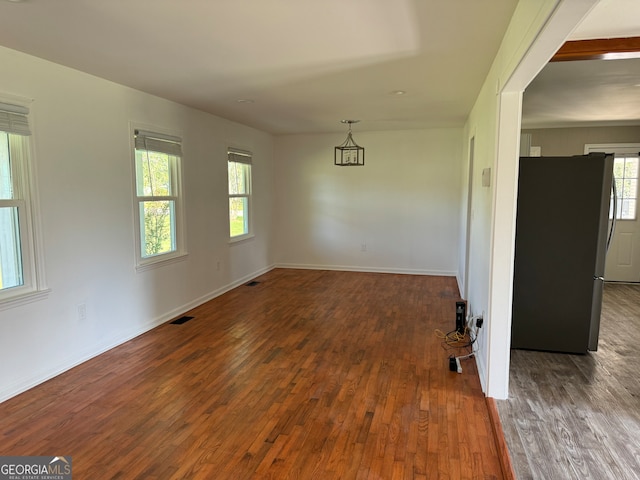 empty room with dark wood-type flooring