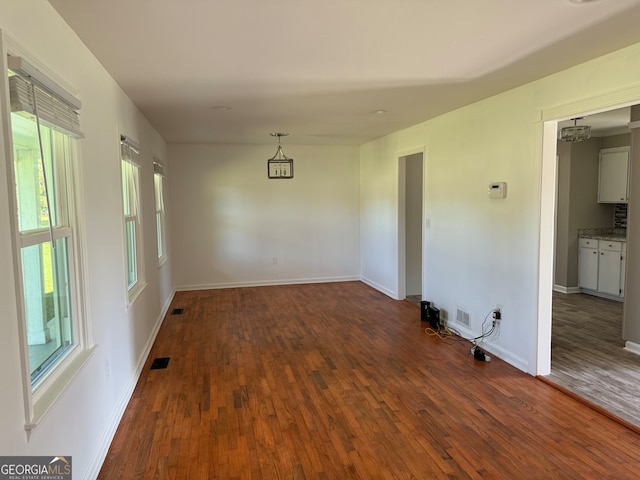 spare room with dark hardwood / wood-style flooring