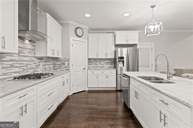 kitchen featuring white cabinets, appliances with stainless steel finishes, wall chimney exhaust hood, and sink