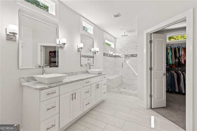 bathroom with vanity and tiled shower