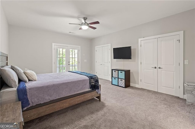 carpeted bedroom with ceiling fan, multiple closets, french doors, and access to exterior