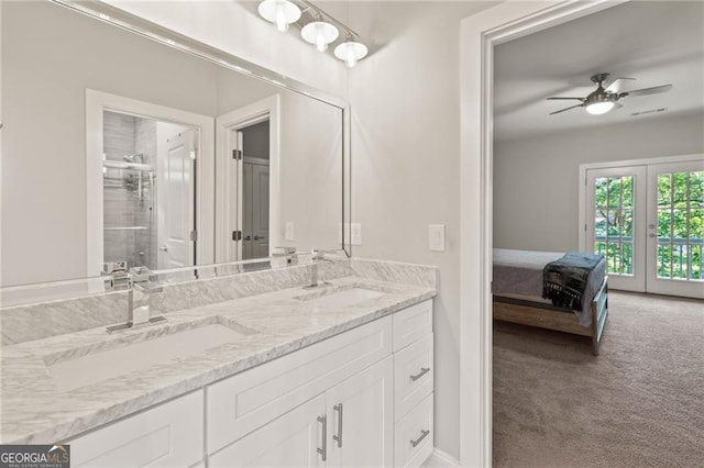 bathroom with french doors, a shower with shower door, vanity, and ceiling fan