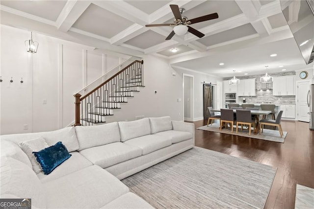 living room with beamed ceiling, ceiling fan, hardwood / wood-style floors, coffered ceiling, and ornamental molding