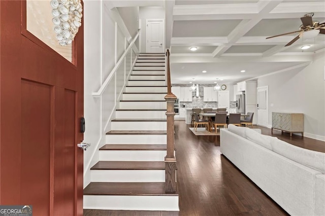 staircase with ceiling fan, beamed ceiling, coffered ceiling, and hardwood / wood-style floors