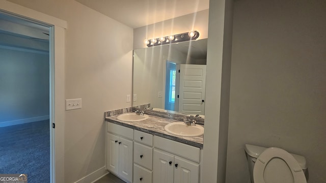 bathroom featuring vanity and toilet