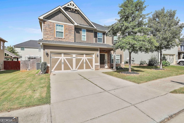 craftsman house with a garage and a front yard