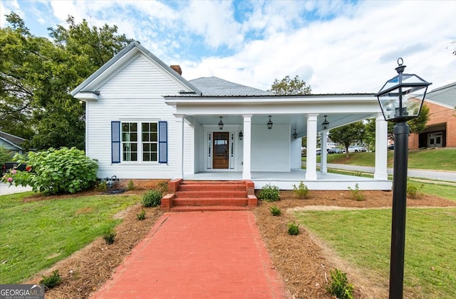 view of front of home with a porch and a front lawn