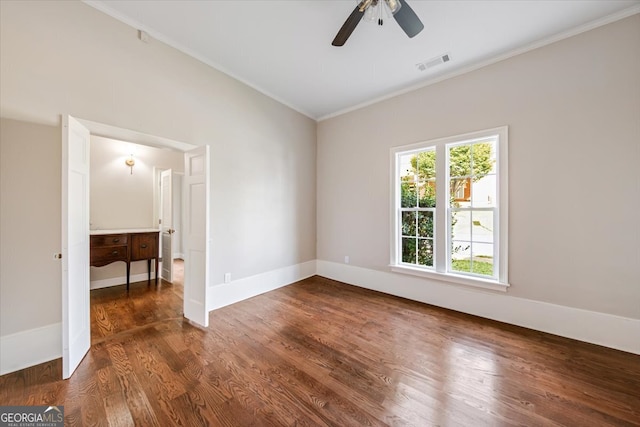 empty room featuring ceiling fan, dark wood-type flooring, and crown molding