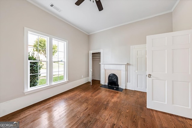 unfurnished living room with ornamental molding, dark hardwood / wood-style floors, and ceiling fan