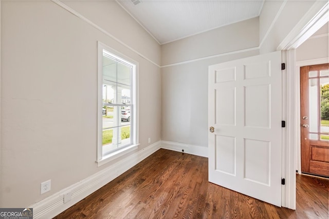 unfurnished room with dark hardwood / wood-style flooring