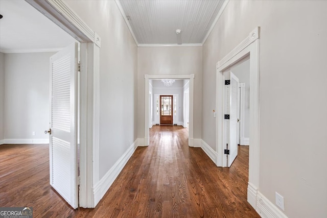 hall featuring crown molding and dark wood-type flooring