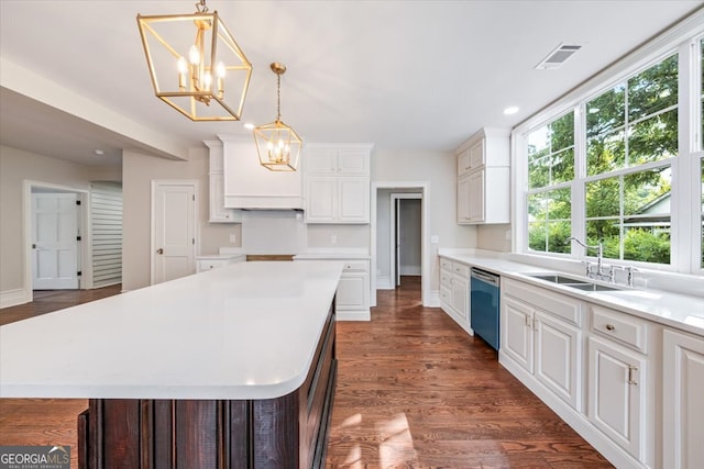 kitchen featuring hanging light fixtures, sink, dishwasher, dark hardwood / wood-style floors, and a center island