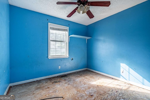 spare room with a textured ceiling and ceiling fan