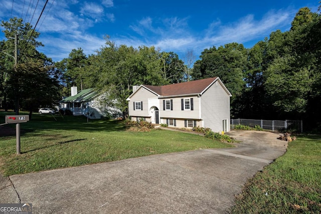 raised ranch with a front lawn