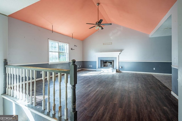 unfurnished living room featuring ceiling fan, dark hardwood / wood-style flooring, and lofted ceiling