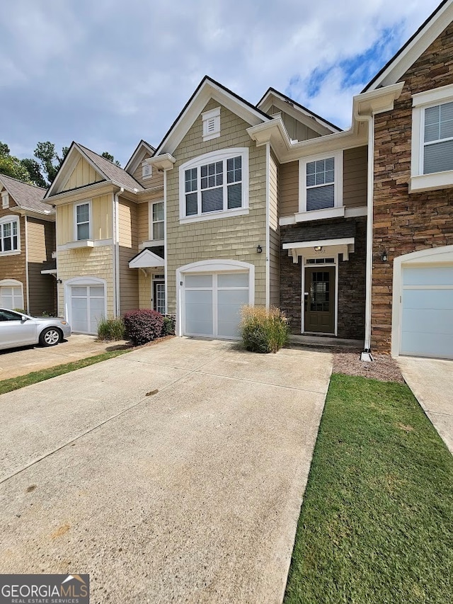 townhome / multi-family property featuring a garage