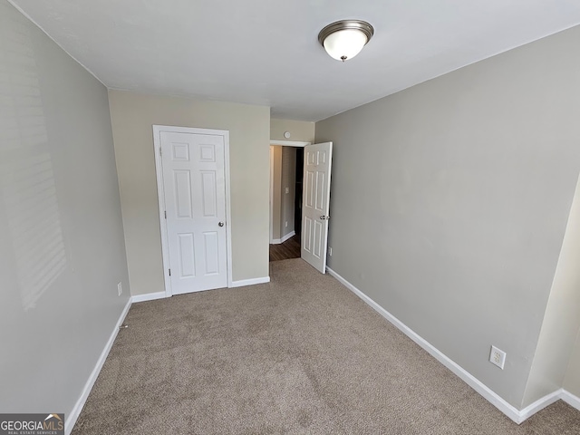 unfurnished bedroom featuring a closet and carpet