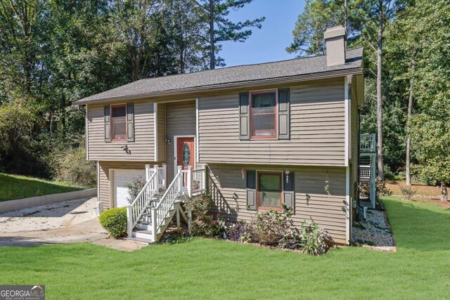 4693 Hairston Crossing Rd, Stone Mountain, GA 30083 - split foyer home with a chimney, a front yard, a garage, and driveway