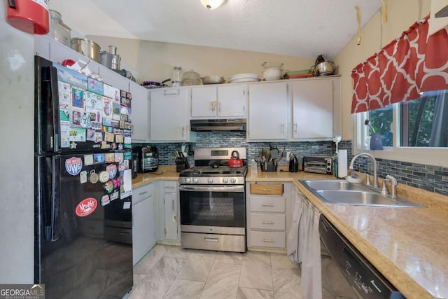 kitchen with backsplash, sink, black appliances, vaulted ceiling, and white cabinetry