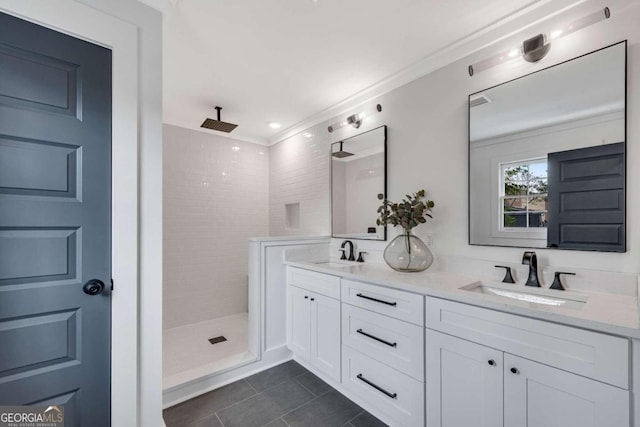full bathroom with double vanity, walk in shower, tile patterned flooring, and a sink