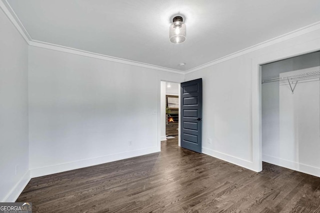 unfurnished bedroom with baseboards, wood finished floors, and ornamental molding
