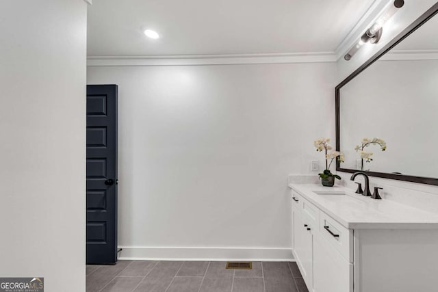 bathroom featuring vanity, baseboards, ornamental molding, tile patterned flooring, and visible vents