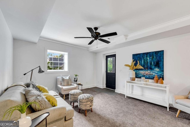 carpeted living area featuring ceiling fan, baseboards, and ornamental molding