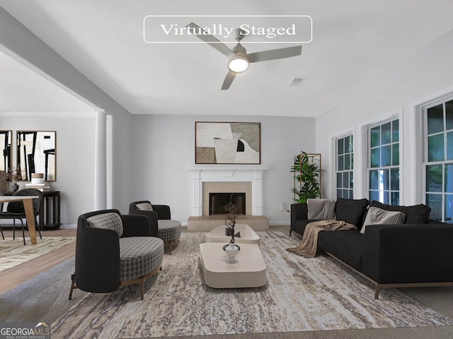 living room with decorative columns, ceiling fan, and hardwood / wood-style flooring