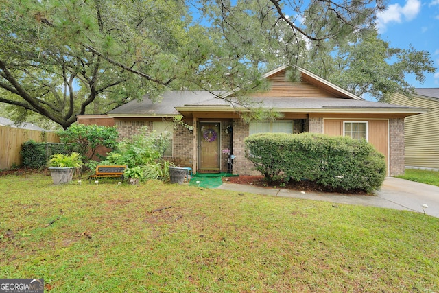 ranch-style home featuring a front yard