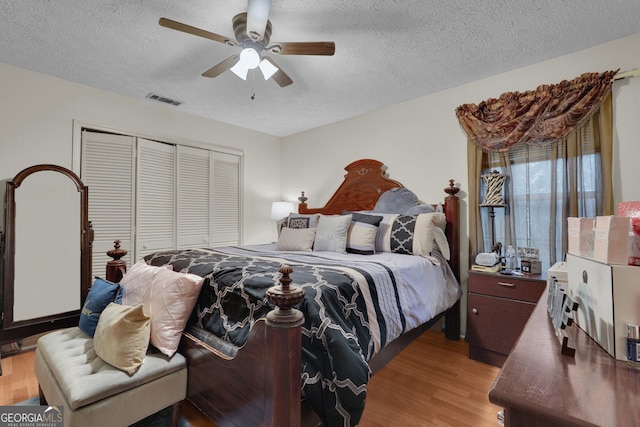 bedroom featuring ceiling fan, a closet, and light hardwood / wood-style floors