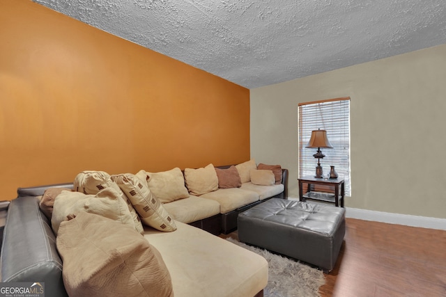 living room featuring a textured ceiling and hardwood / wood-style floors