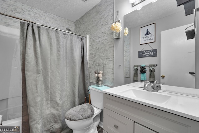 full bathroom featuring vanity, shower / bathtub combination with curtain, toilet, and a textured ceiling