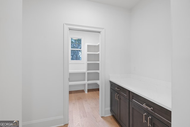 spacious closet featuring light wood-type flooring